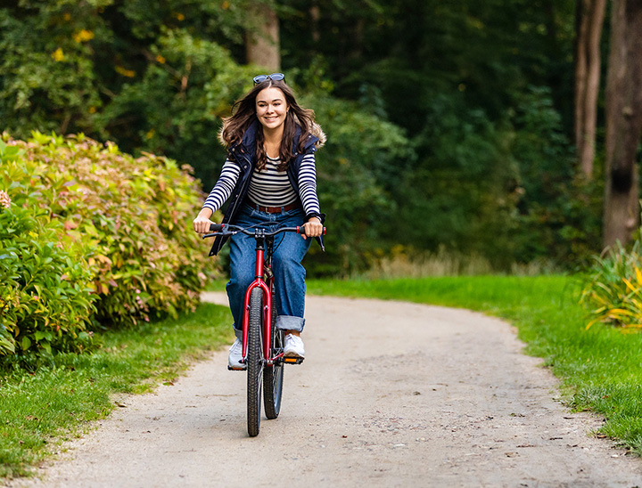 Image of person riding a bicycle on a cycle path.