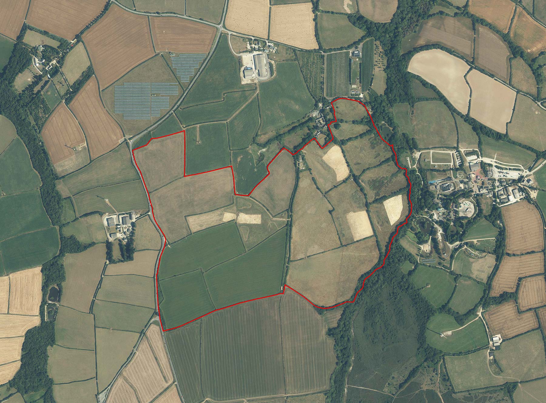 Red line indicating the Tredinnick Garden Village site. The site is located southwest of Tredinnick